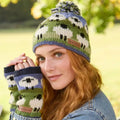 Woman wearing a knitted hat and gloves with sheep pattern outdoors