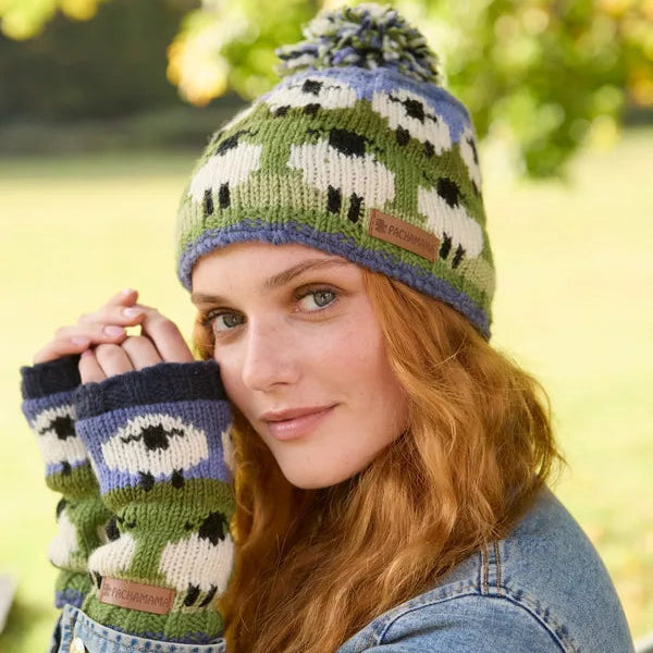 Woman wearing a knitted hat and gloves with sheep pattern outdoors