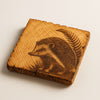 Wooden coaster with a hedgehog engraving on a beige background