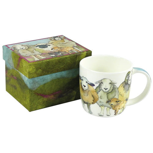 A ceramic mug with a sheep design, placed next to its box which also features a sheep design.