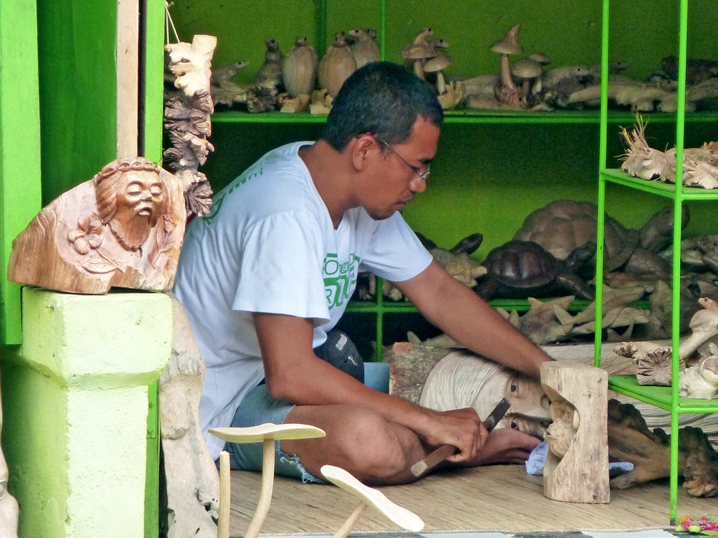 A carver at work in his workshop in Bali