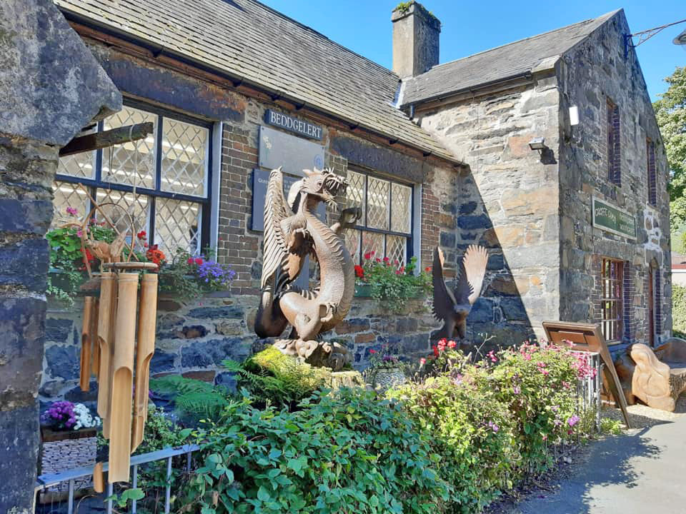 The Beddgelert Woodcraft shop front with a carved dragon outside